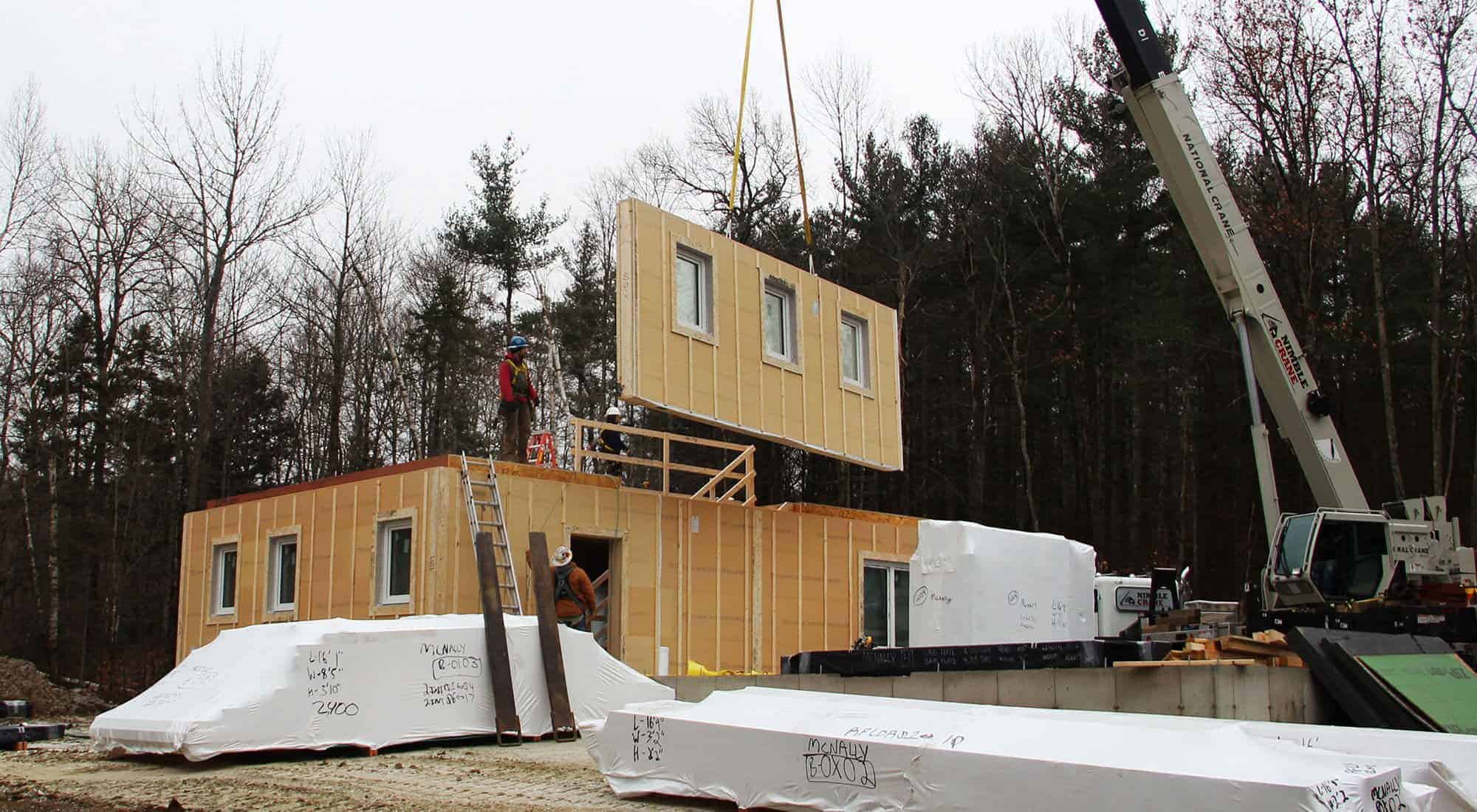 Unity Homes on-site home assembly with crane.